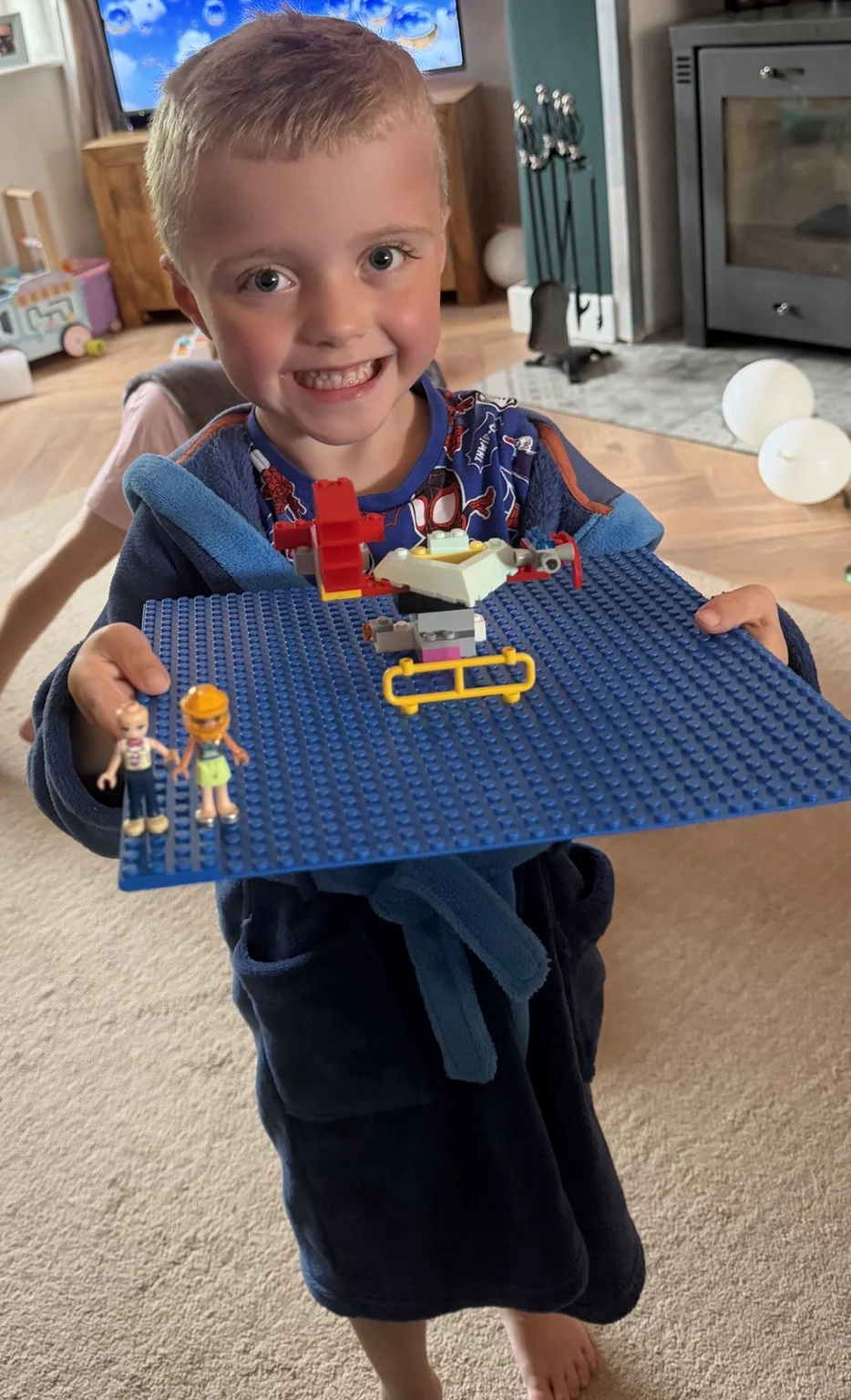 Harry proudly holding something he built